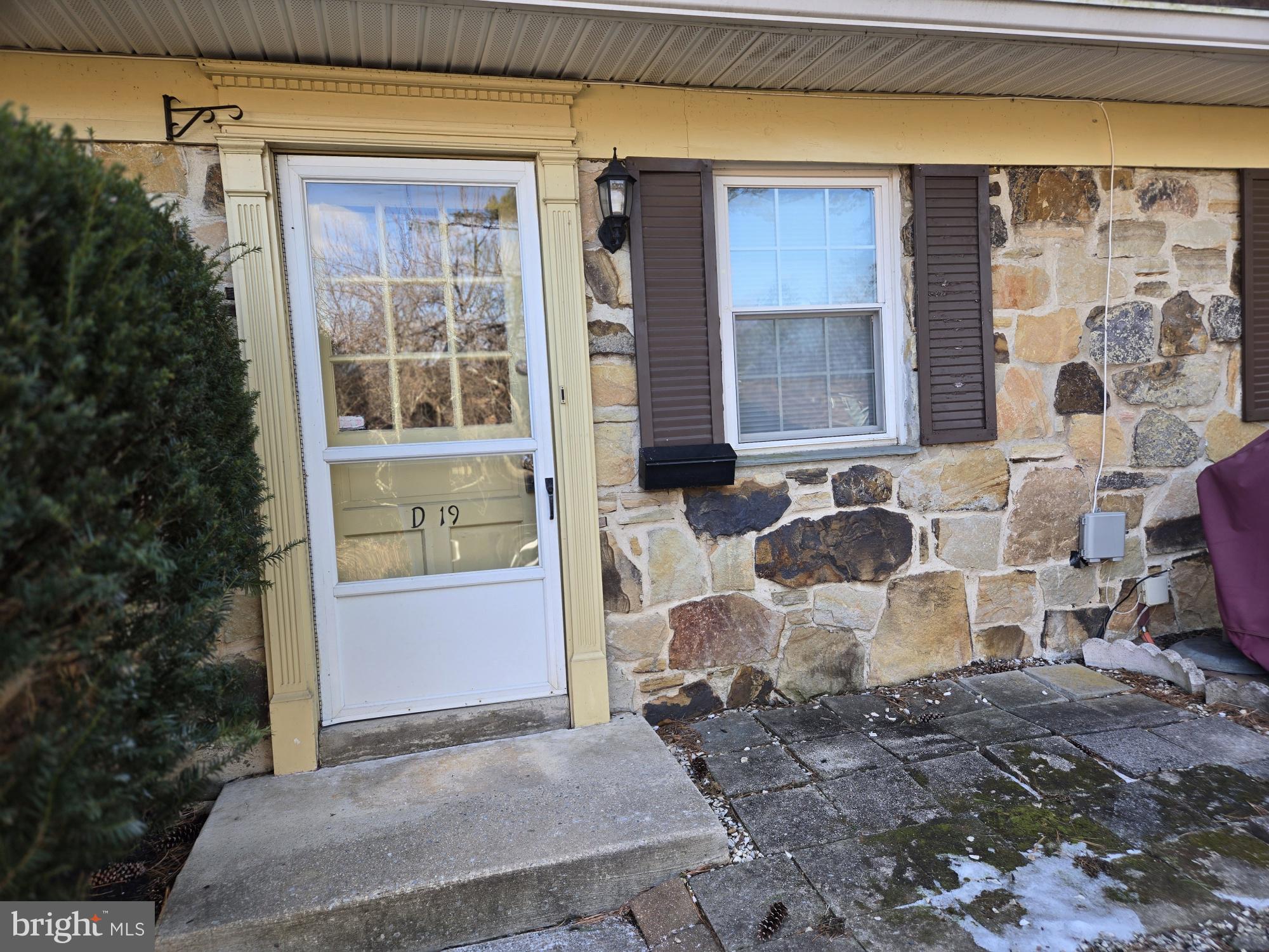 a view of a front door of house with a chair