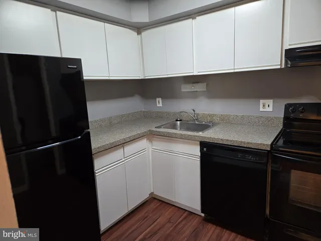 a kitchen with a sink and a refrigerator