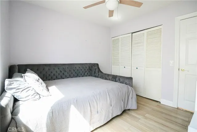 a bedroom with a bed and a lamp on the dresser