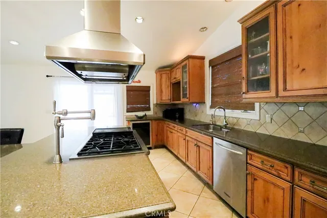 a kitchen with stainless steel appliances a sink stove and cabinets