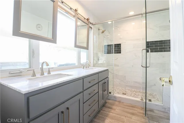 a bathroom with a granite countertop sink mirror and double