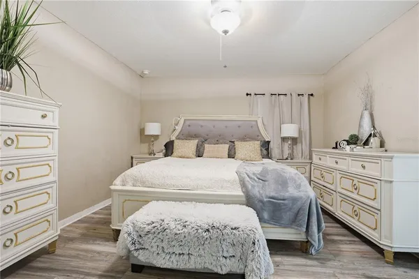 a bedroom with a bed and wooden floor