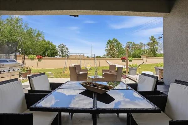 an outdoor sitting area with furniture and wooden floor