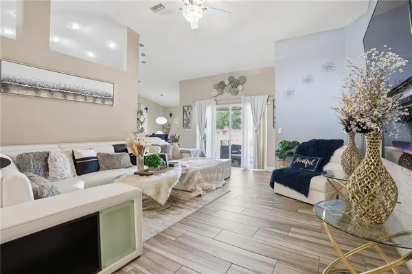 a living room with furniture and a chandelier