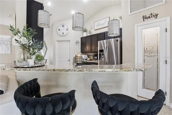 a living room with furniture and a clock