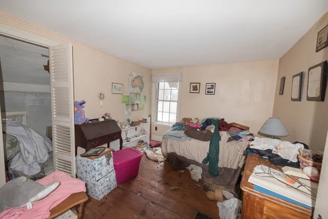 a bedroom with a bed and a table