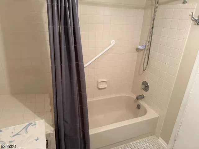 a bathroom with a bathtub and shower