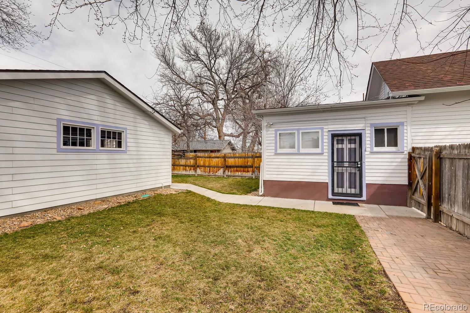 4445 Perry Street Denver, CO 80212 - Photo 17 of 19 a view of a backyard with a large tree
