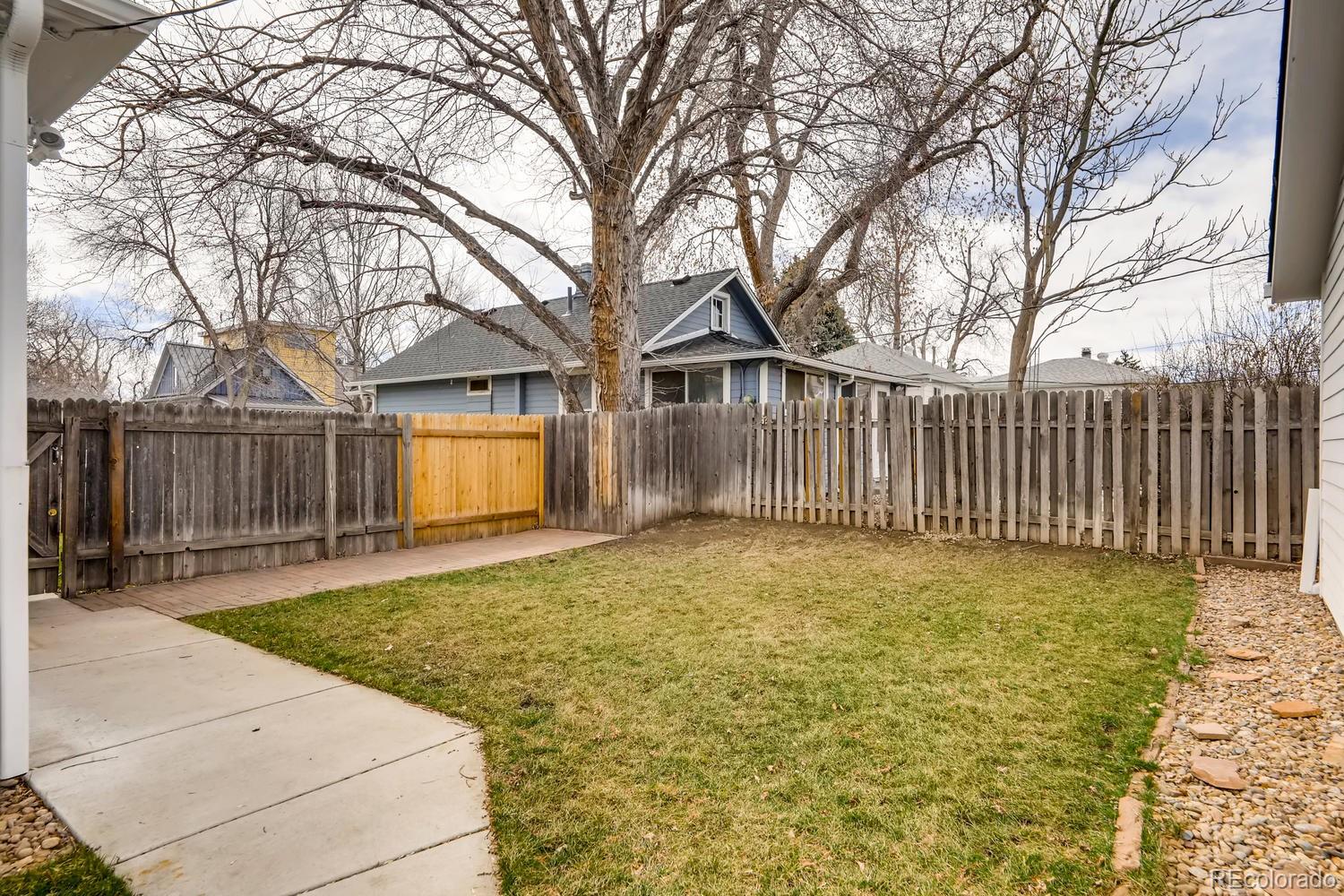 4445 Perry Street Denver, CO 80212 - Photo 18 of 19 a backyard of a house with table and chairs