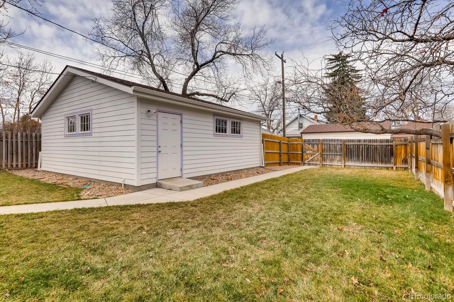 4445 Perry Street Denver, CO 80212 - Photo 19 of 19 a view of a house with a yard