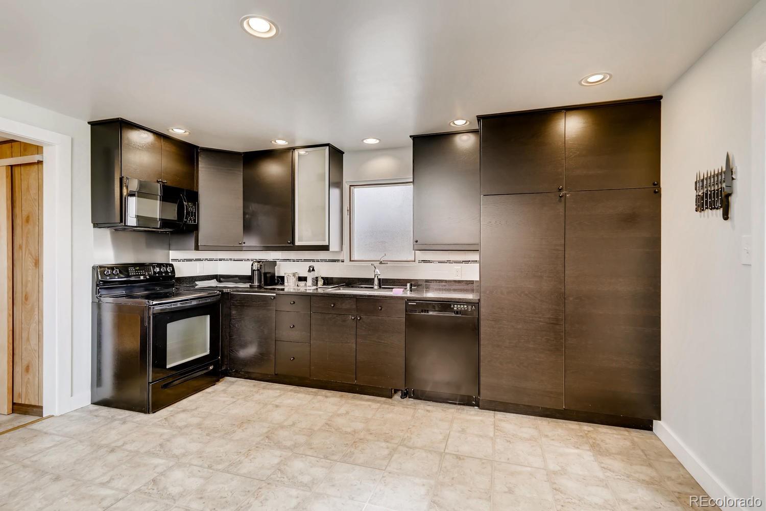 4445 Perry Street Denver, CO 80212 - Photo 5 of 19 a kitchen with stainless steel appliances granite countertop a refrigerator and a stove