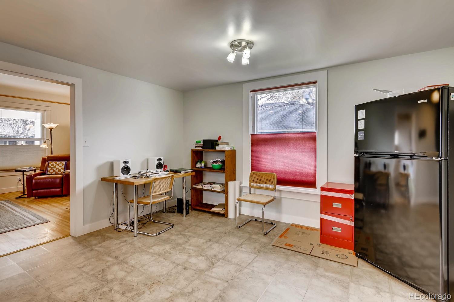 4445 Perry Street Denver, CO 80212 - Photo 7 of 19 a bedroom with furniture and a lamp