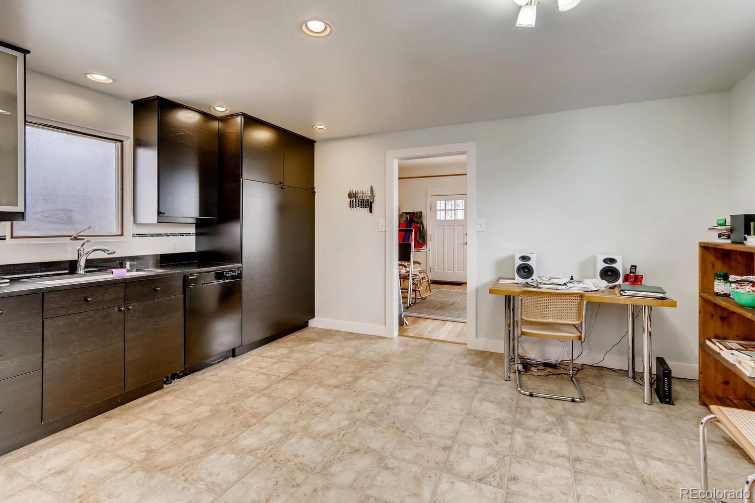 4445 Perry Street Denver, CO 80212 - Photo 8 of 19 a kitchen with stainless steel appliances kitchen island granite countertop a sink and cabinets