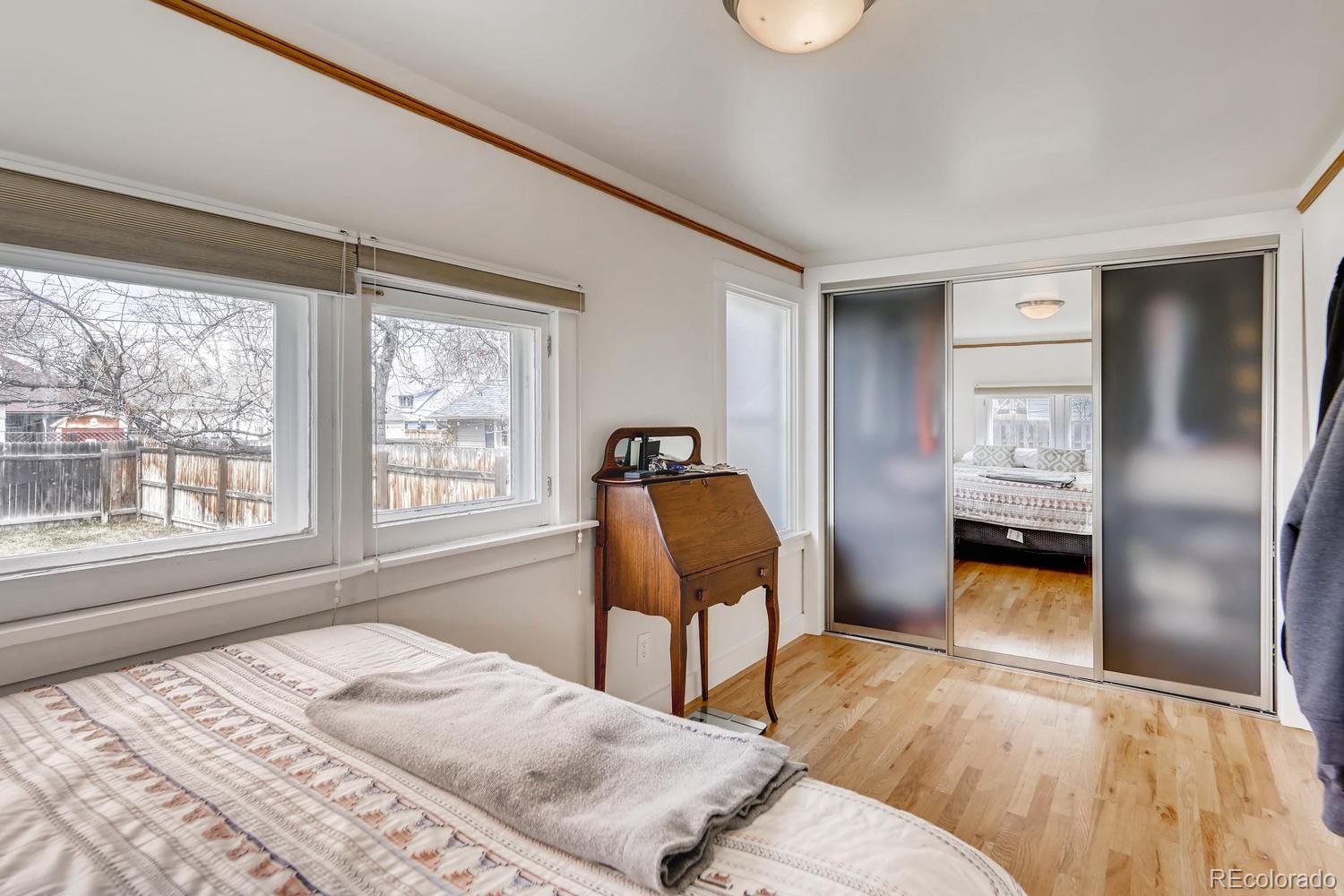4445 Perry Street Denver, CO 80212 - Photo 10 of 19 a bedroom with a bed and a chair