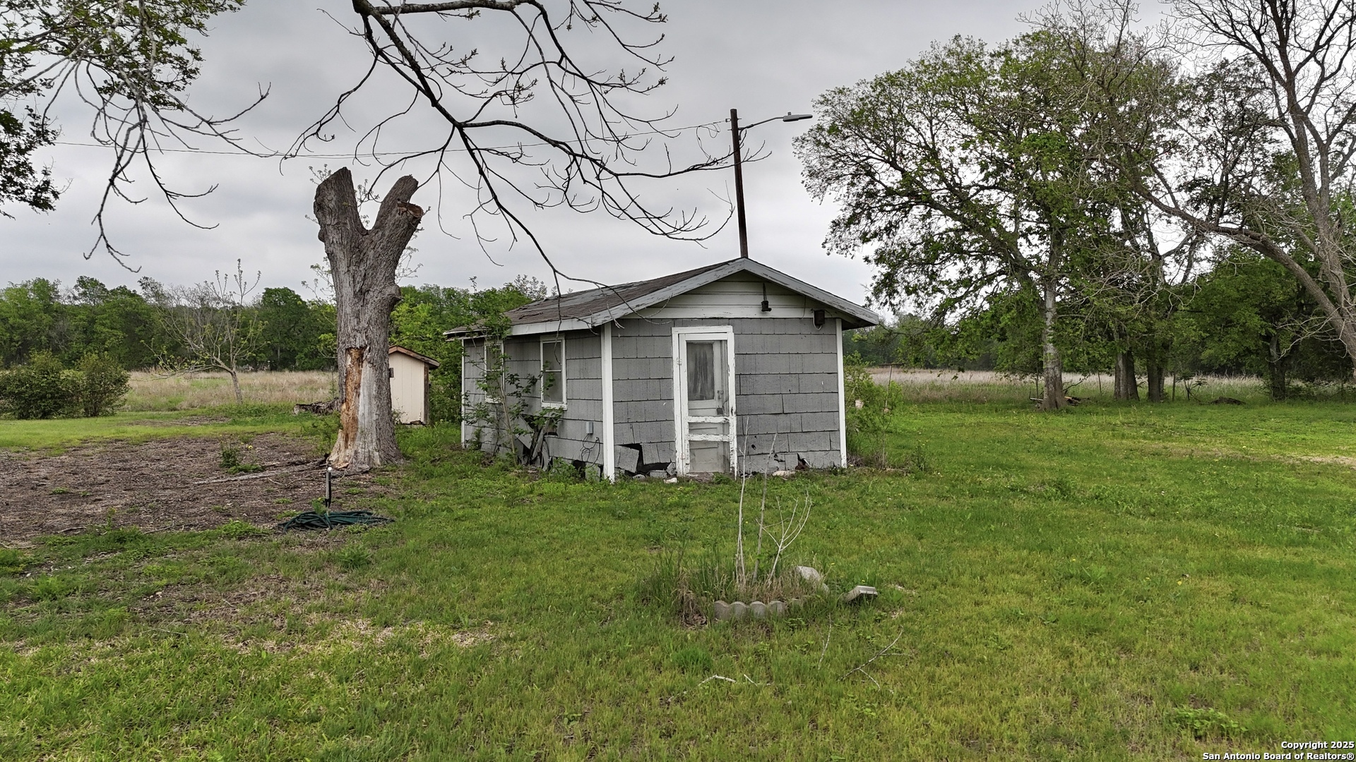 2197 Fm 1984 Maxwell, TX 78656 - Photo 9 of 9 a yellow house with a big yard and large trees