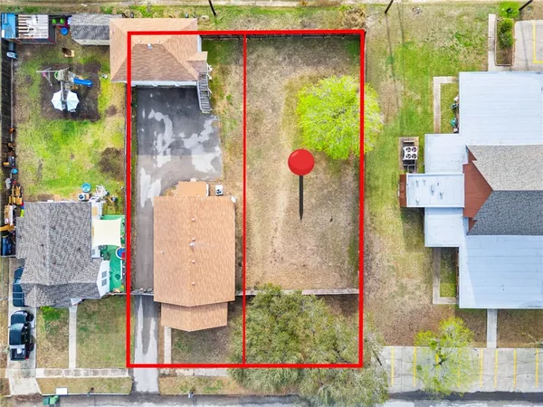 an aerial view of residential houses with outdoor space and street view