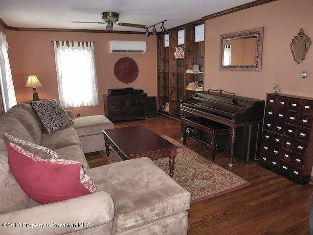 3441 Madisonville Road Moscow, PA 18444 - Photo 14 of 28 a living room with furniture a wooden floor and a fireplace