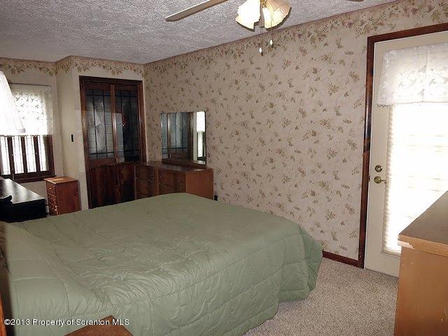 3441 Madisonville Road Moscow, PA 18444 - Photo 16 of 28 a bedroom with a bed and a television