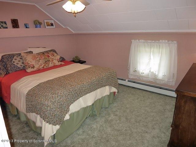 3441 Madisonville Road Moscow, PA 18444 - Photo 18 of 28 a bed sitting in a bedroom next to a window
