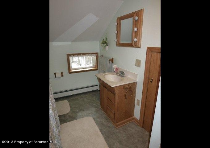 3441 Madisonville Road Moscow, PA 18444 - Photo 19 of 28 a bathroom with a sink and mirror