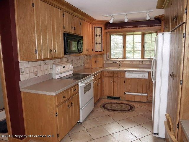 3441 Madisonville Road Moscow, PA 18444 - Photo 3 of 28 a kitchen with a sink stove and microwave