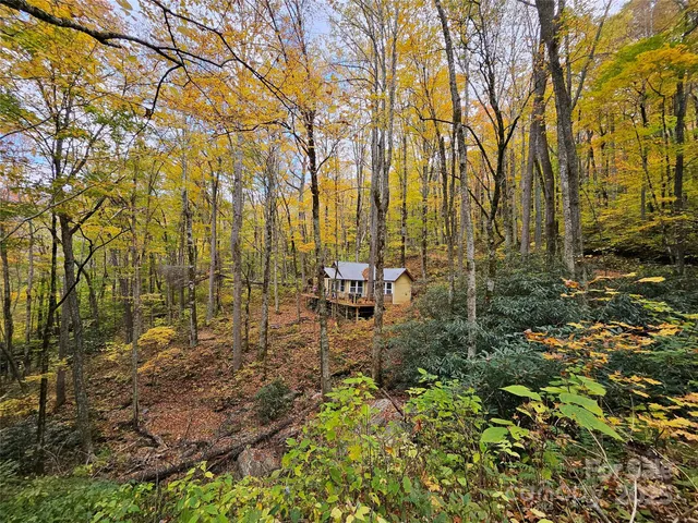 a front view of a house with yard and sitting area
