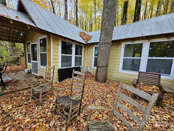 a view of a house with a patio and wooden fence