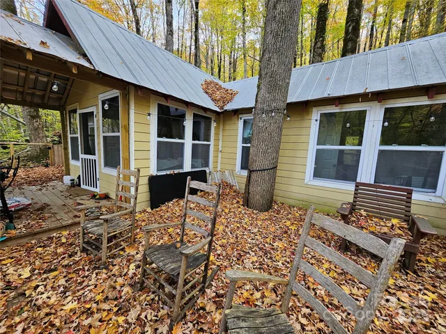 a view of a house with a patio and wooden fence