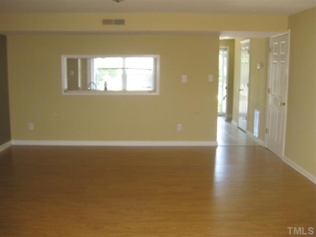 7727 Bernadette Lane Raleigh, NC 27615 - Photo 2 of 7 a view of a room with wooden floor and a window