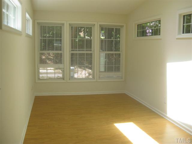 7727 Bernadette Lane Raleigh, NC 27615 - Photo 4 of 7 a view of empty room with windows
