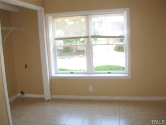 7727 Bernadette Lane Raleigh, NC 27615 - Photo 6 of 7 a view of an empty room with a window
