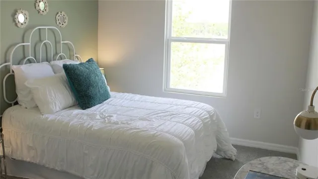 a bedroom with a bed and a window