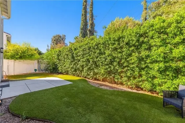 a view of a backyard with swimming pool