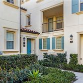 front view of a brick house with a large windows and a potted plant