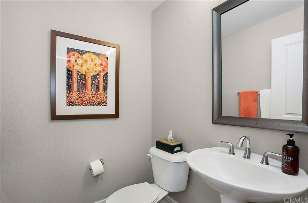 72 Capricorn Irvine, CA 92618 - Photo 13 of 24 a bathroom with a toilet sink and mirror