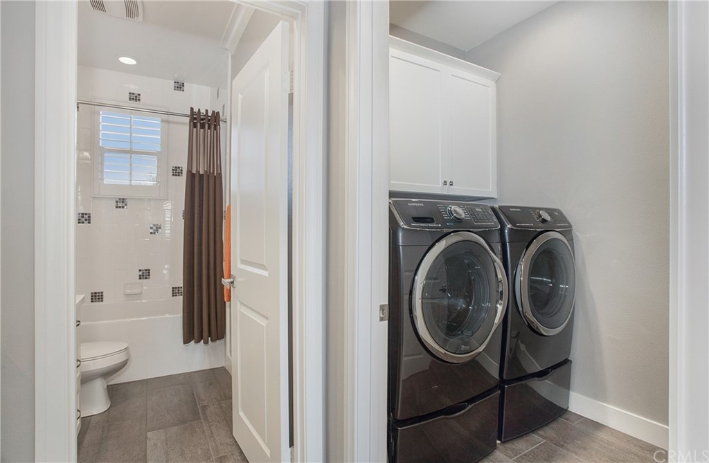72 Capricorn Irvine, CA 92618 - Photo 20 of 24 a view of a bathroom with washing machine and a sink