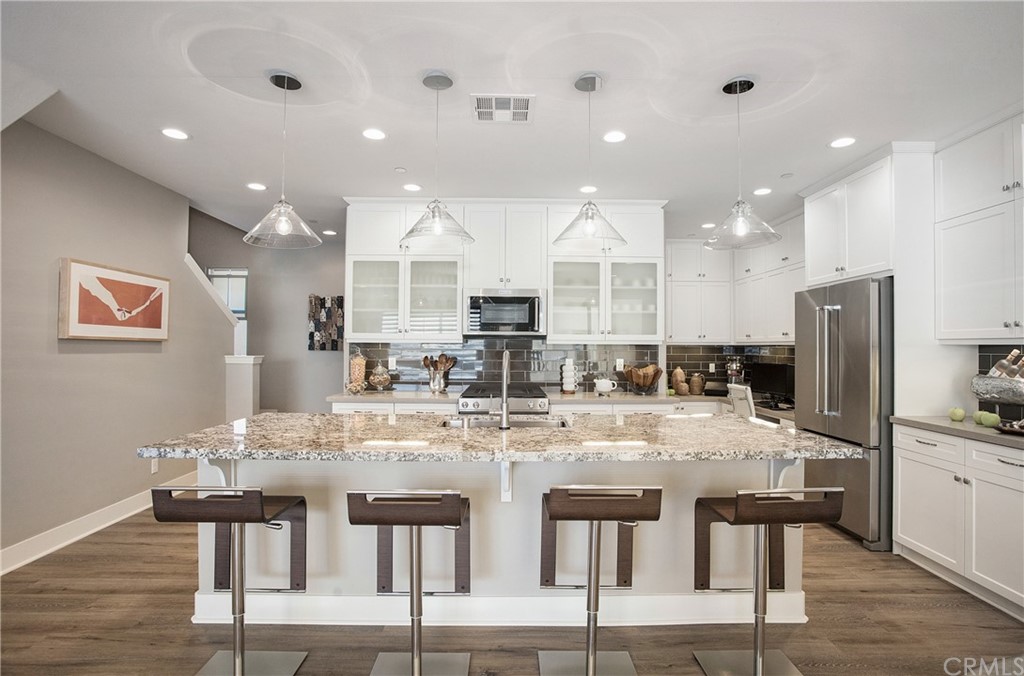 72 Capricorn Irvine, CA 92618 - Photo 4 of 24 a large kitchen with a table and chairs