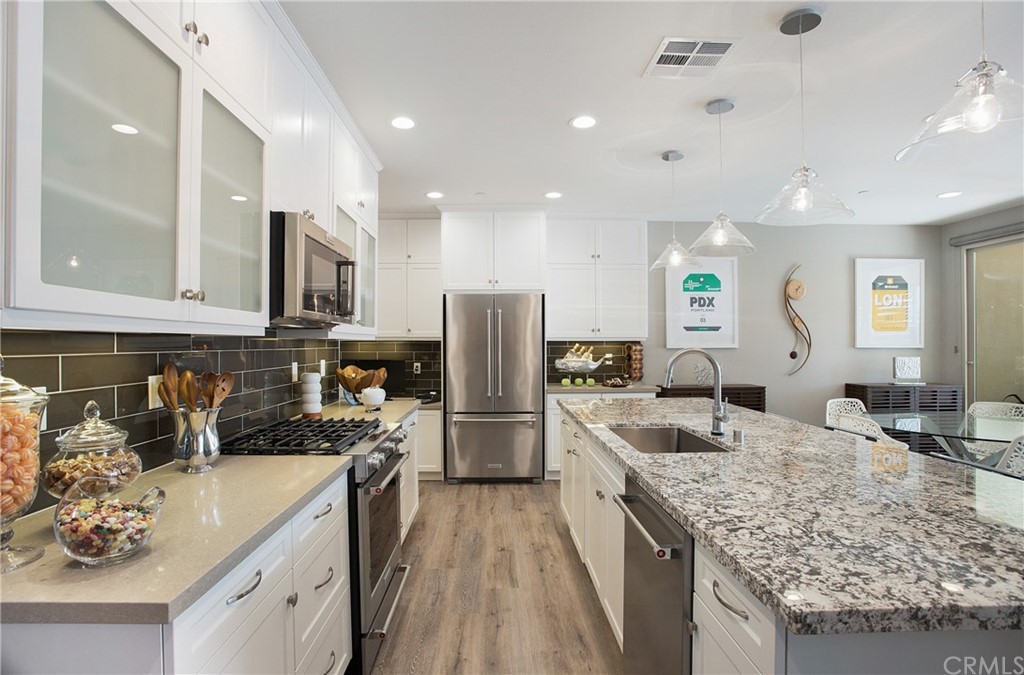 72 Capricorn Irvine, CA 92618 - Photo 9 of 24 a kitchen with a sink stove and refrigerator