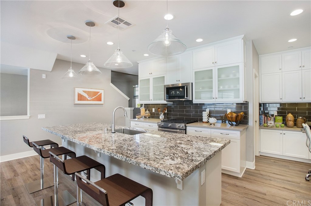 72 Capricorn Irvine, CA 92618 - Photo 10 of 24 a kitchen with a table and chairs in it