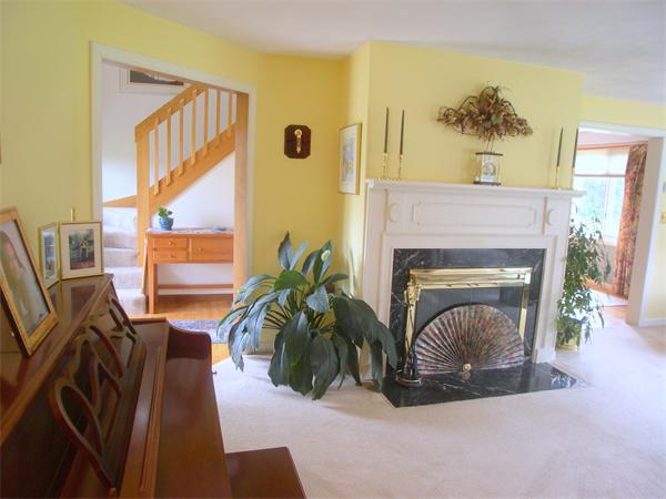 9 Garvey Road Framingham, MA 01701 - Photo 12 of 30 a living room with furniture and a fireplace