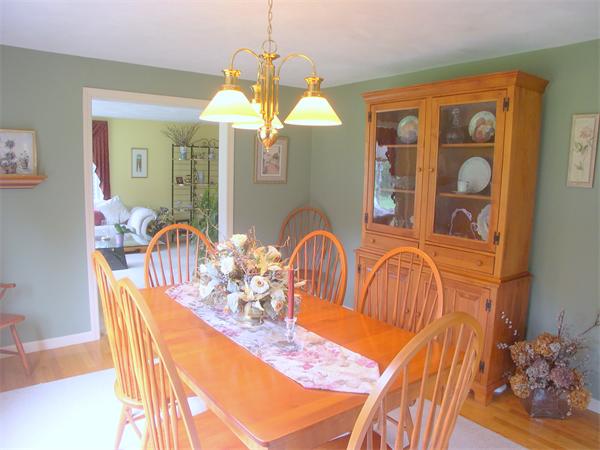 9 Garvey Road Framingham, MA 01701 - Photo 14 of 30 a view of a dining room with furniture chandelier and wooden floor