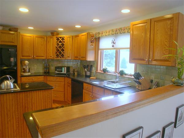9 Garvey Road Framingham, MA 01701 - Photo 16 of 30 a kitchen with kitchen island granite countertop a sink and counter top space