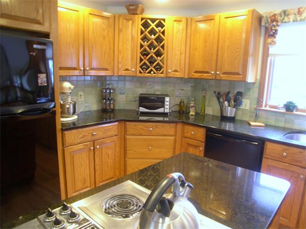9 Garvey Road Framingham, MA 01701 - Photo 17 of 30 a kitchen with stainless steel appliances granite countertop a sink a stove and a refrigerator