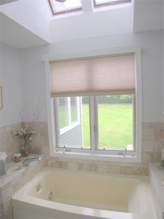 9 Garvey Road Framingham, MA 01701 - Photo 20 of 30 a bath tub sitting in a bathroom next to a window