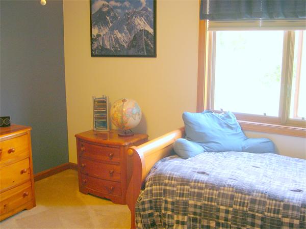 9 Garvey Road Framingham, MA 01701 - Photo 24 of 30 a bedroom with a bed and wooden floor