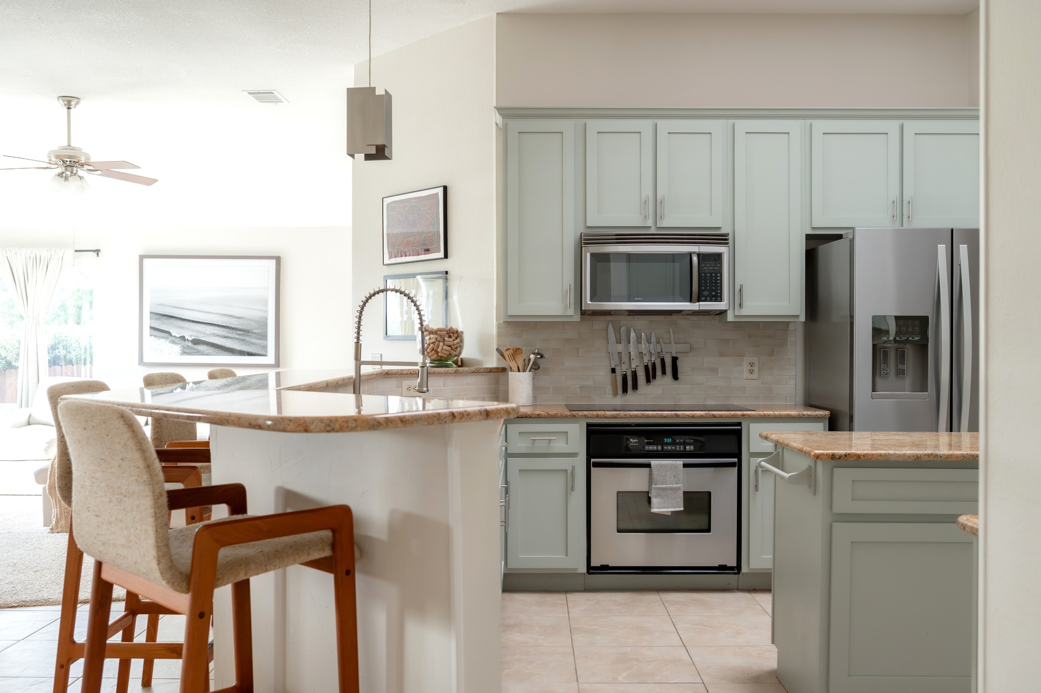 a kitchen with stainless steel appliances a stove sink and microwave
