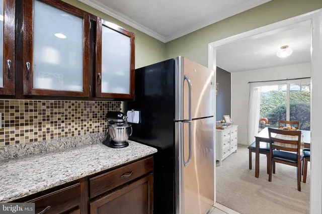 a kitchen with a refrigerator and a sink