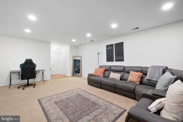 a living room with furniture and a rug