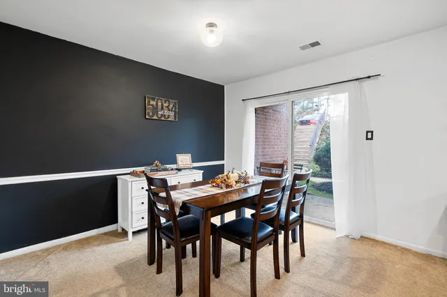 a view of a dining room with furniture and window