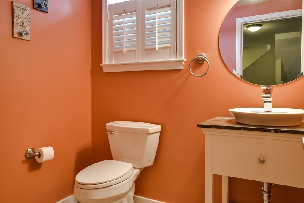 22 Hardwick Road Ashland, MA 01721 - Photo 23 of 24 a bathroom with a toilet a sink and mirror